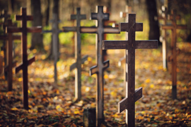 Old orthodox cemetery – wooden crosses in sunlight, shallow dof