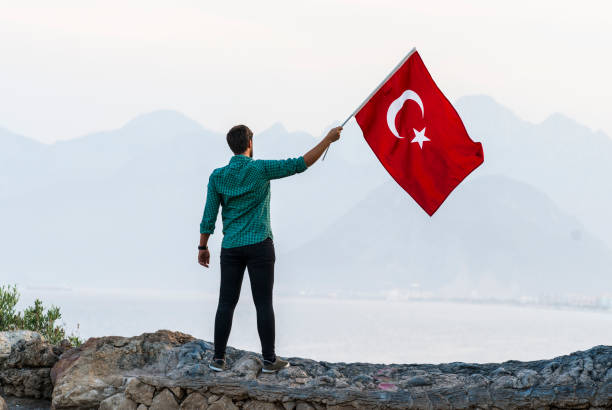 istock Young man flying Turkish flag 976761670