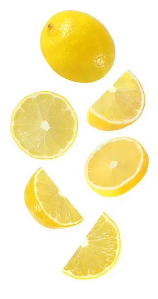 Photo of falling, hanging, flying whole and half piece of lemon fruits isolated on white background with clipping path