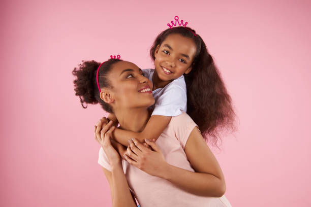 istock Afro American daughter on piggy back ride 976772358