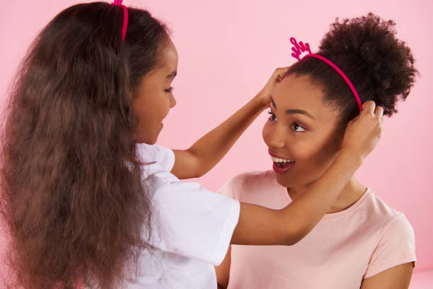 istock African American daughter puts crown on head 976774522