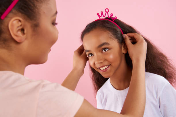 istock African American mother puts crown on head 976777464