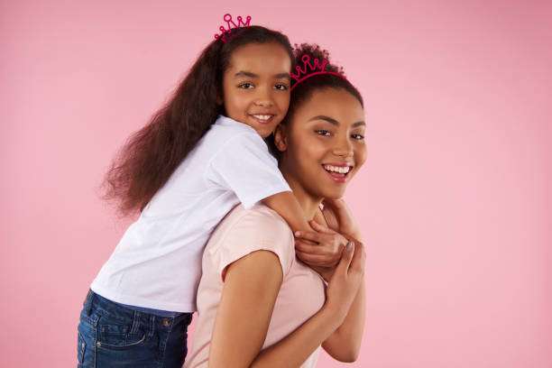 istock Afro American daughter on piggy back ride 976784836