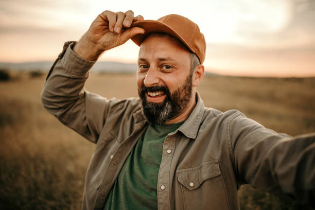 Man making selfie in filed of wheat