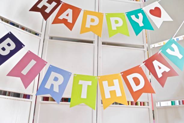 istock Happy birthday text on  white wooden wall 976789612