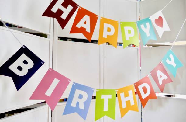 istock Happy birthday text on  white wooden wall 976789674