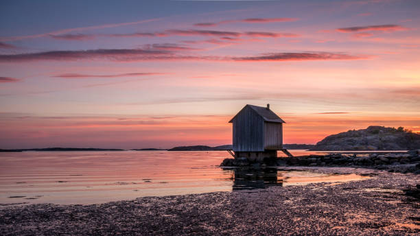 Beautiful sunset over Baltic sea near Gothenburg city, Sweden. Wooden house on seacoast stock photo