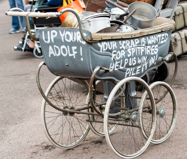 During World War II in England a campaign was launched which asked for people to donate saucepans which were then melted down and used to build Spitfire Aircraft. Photo taken at the Great Central Railway 1940s weekend. The Railway runs between Leicester and Loughborough in England.