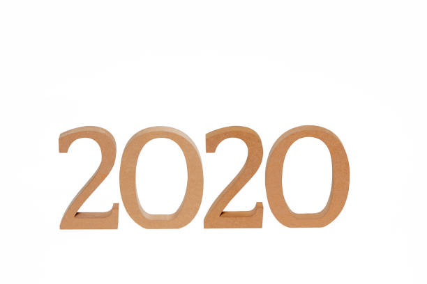 istock Year 2020 in wooden numbers on white background 976797548