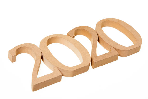 istock Year 2020 in wooden numbers on white background 976799644