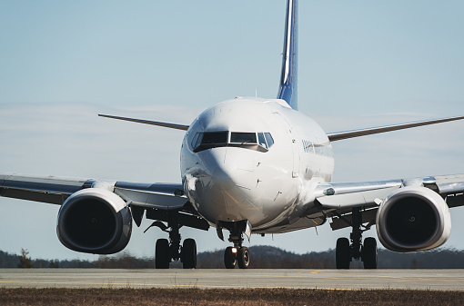 Passenger jet on airport taxiway.