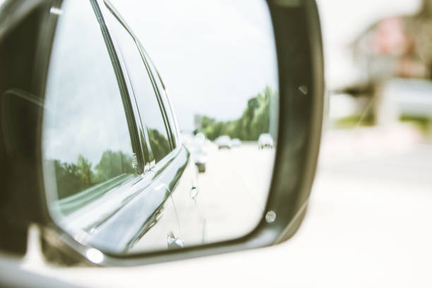 istock View of side of car through side mirror 976847448