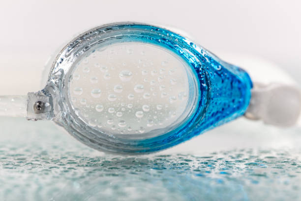 Wet blue goggles for swimming. Isolated on white background.