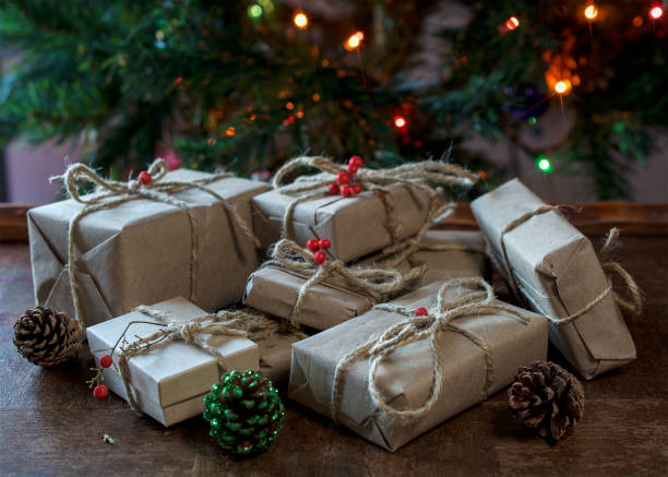istock Presents wrapped in tan ecological recycled paper underneath christmas tree 976858768