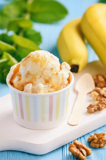 istock Vanilla and banana ice-cream with nuts and caramel. 976868878