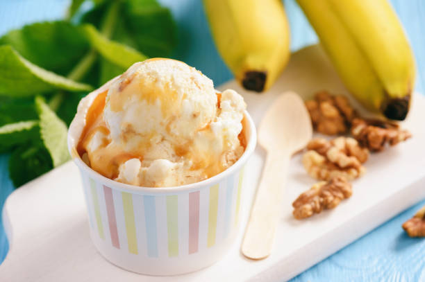 istock Vanilla and banana ice-cream with nuts and caramel. 976868884