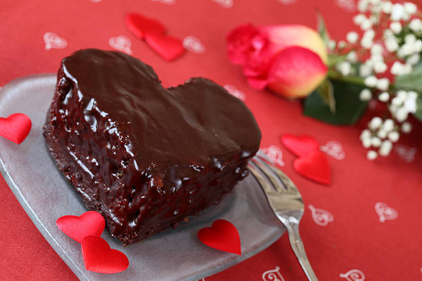 A heart shaped red cake inside the plate.