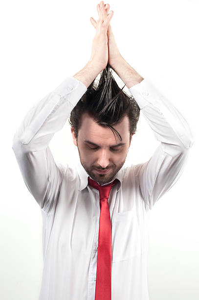 istock man in white shirt holding his hands up 97687434