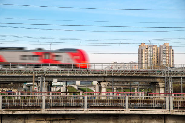 istock Fast modern metro train on the city background. 976876016