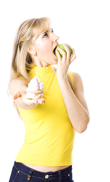 istock Young beautiful women eating apple and refusing cookies 97687883