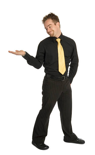 product placement well dressed man standing looking at empty outstretched hand. ready for product placement. male is standing and shows outstretched hand with open palm stock pictures, royalty-free photos & images