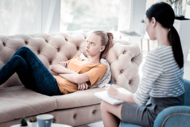 istock Pessimistic girl lying on the sofa during psychological appointment 976890490