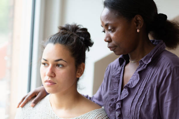istock Psychotherapy:  Mental health professional consoling patient 976894446