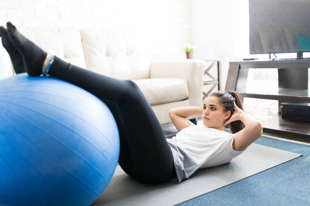 istock Woman doing crunches with pilates ball 976899668