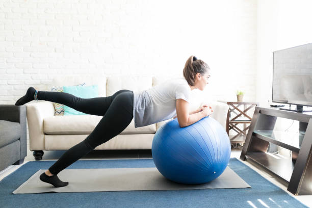 istock Woman doing stretching with ball 976899818