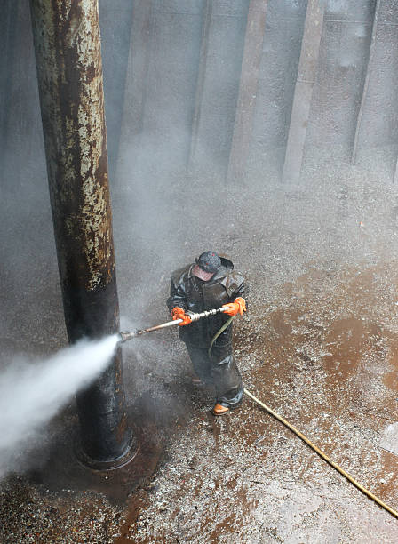 istock worker cleaning column of a ship 97690130