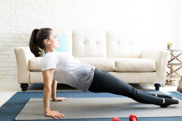 istock Woman doing stretching workout at home 976907106
