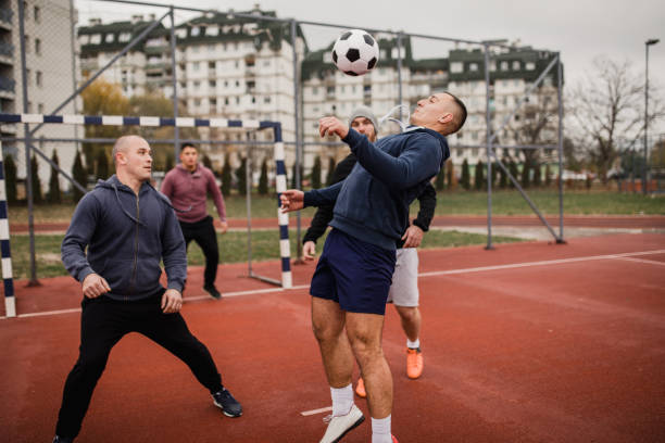 istock Guys playing football 976911254