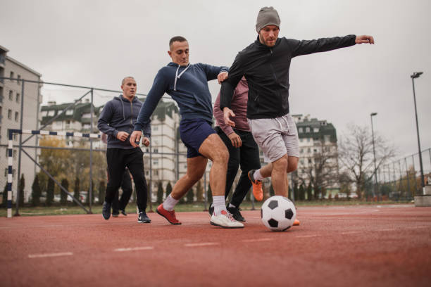 istock Friends playing soccer 976911480