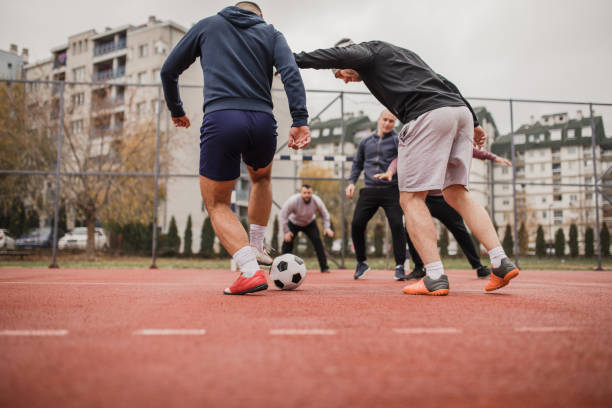 istock Friends playing football 976911580