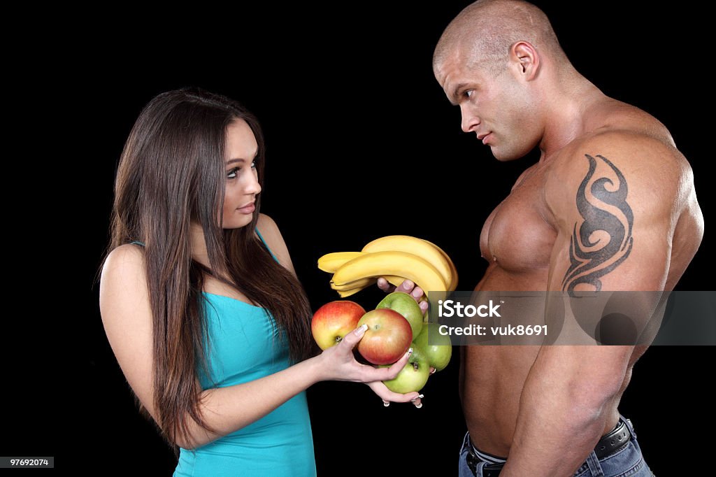Attrayant couple musculaires avec des fruits - Photo de Adulte libre de droits