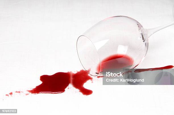 A Glass Of Red Wine Tipped Over On A White Background Stock Photo - Download Image Now