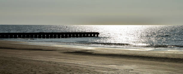 istock Beach with a boardwalk in the sunset 976937320