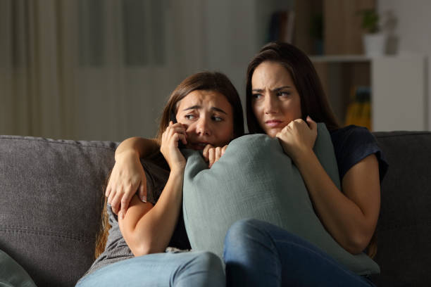 istock Scared friends at home calling police 976958162