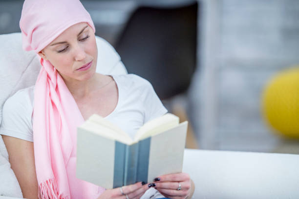 istock Woman with cancer reading a book 976965344