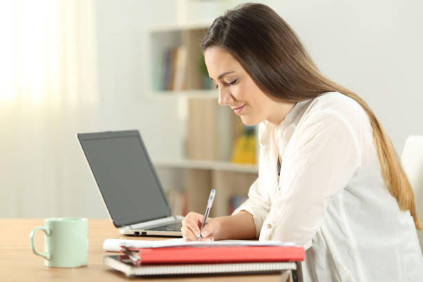 istock Profile of a student taking notes at home 976967142