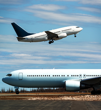 Passenger jets taxiing and taking off.