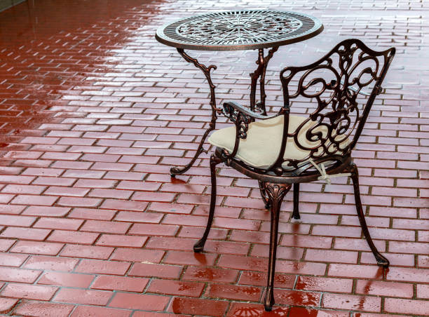 Openwork metal table and chair at the outdoors cafe Openwork metal table and chair at the outdoors cafe after the rain rainy cafe stock pictures, royalty-free photos & images