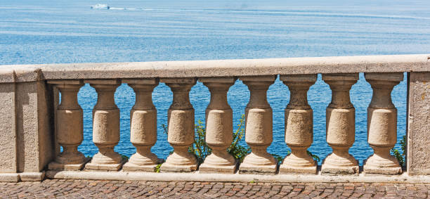 istock Concrete balustrade with blue sea on the background 976974484