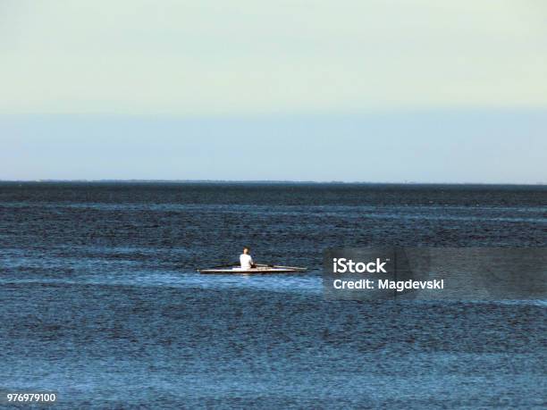 Lonely Man In The Rowboat In The Middle Of The Sea Stock Photo - Download Image Now - Midsection, Kayak, Sea