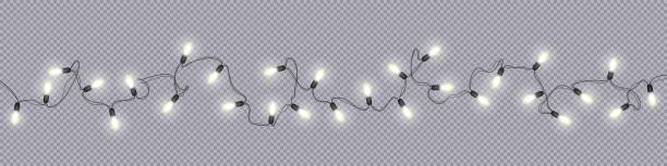 Christmas and New Year garlands with glowing light bulbs Glowing light bulbs Christmas and New Year realistic garlands isolated on transparent background Xmas decorations for festive design of postcards, banners, posters, websites Vector design elements fairy lights stock illustrations