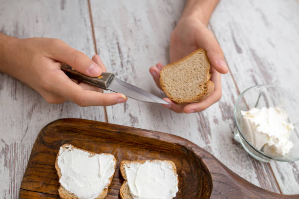istock Butter and bread for breakfast, over rustic wooden background close up 976992320