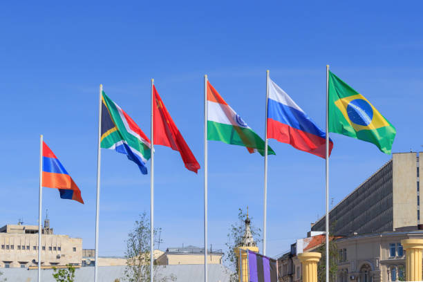 Flags of BRICS countries on a sunny summer morning against blue sky