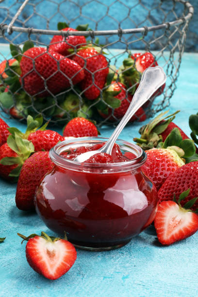 istock strawberry jam with fresh strawberries. marmalade on spoon and jar 977001016