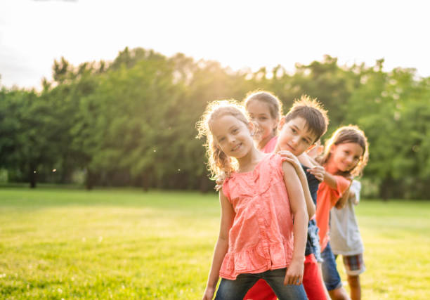 istock Children standing in a row and playing 977005596
