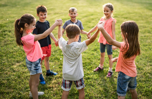 istock Happy kids holding hands in nature 977011554